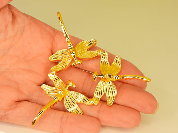 Gold small dragonfly sphere stand in someone's hand. Bottom view