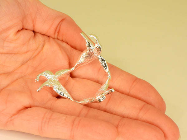 Silver small butterfly sphere stand in someone's hand. Bottom view