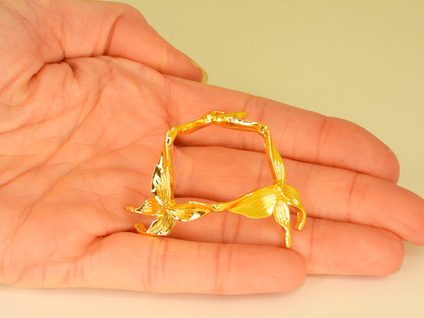 Gold small butterfly sphere stand in someone's hand. Top view