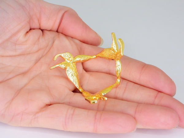 Gold small butterfly sphere stand in someone's hand. Bottom view
