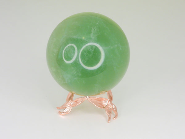 Rose gold small butterfly sphere stand holding a fluorite sphere. Front view