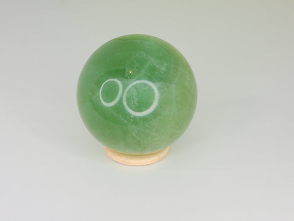 Small wooden ring sphere stand with a sphere. Front view
