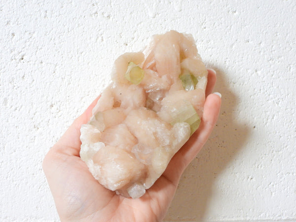 Green Apophyllite with Stilbite cluster in someone's hand