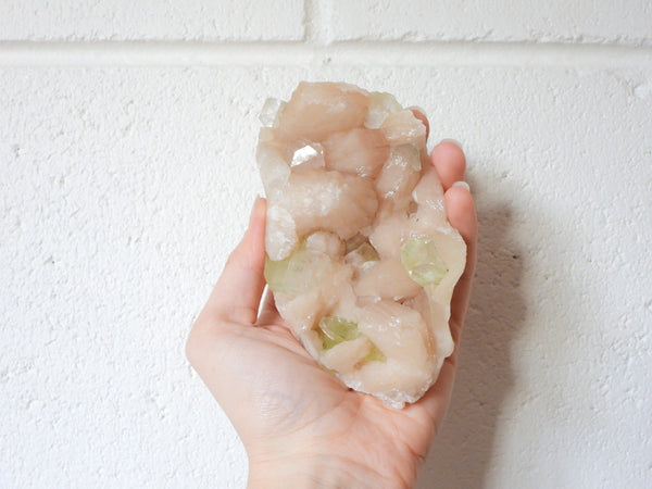 Green Apophyllite with Stilbite cluster in someone's hand